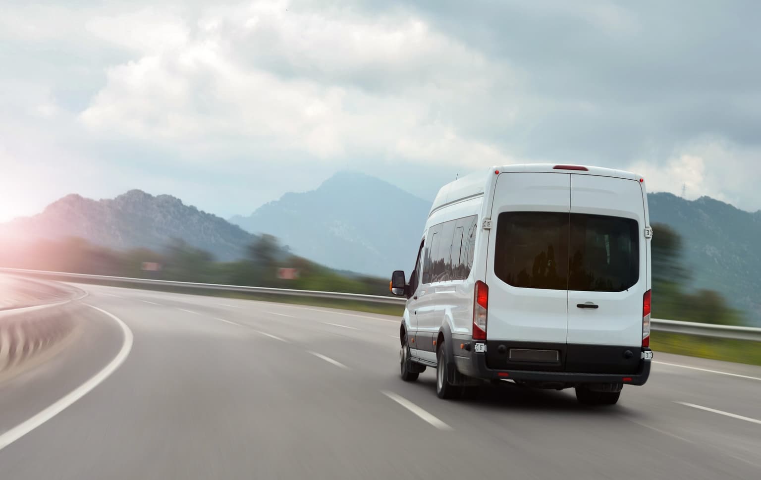 crew transport van driving open road
