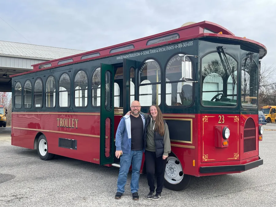 Buyers with their trolley bus at the BusesForSale.com lot